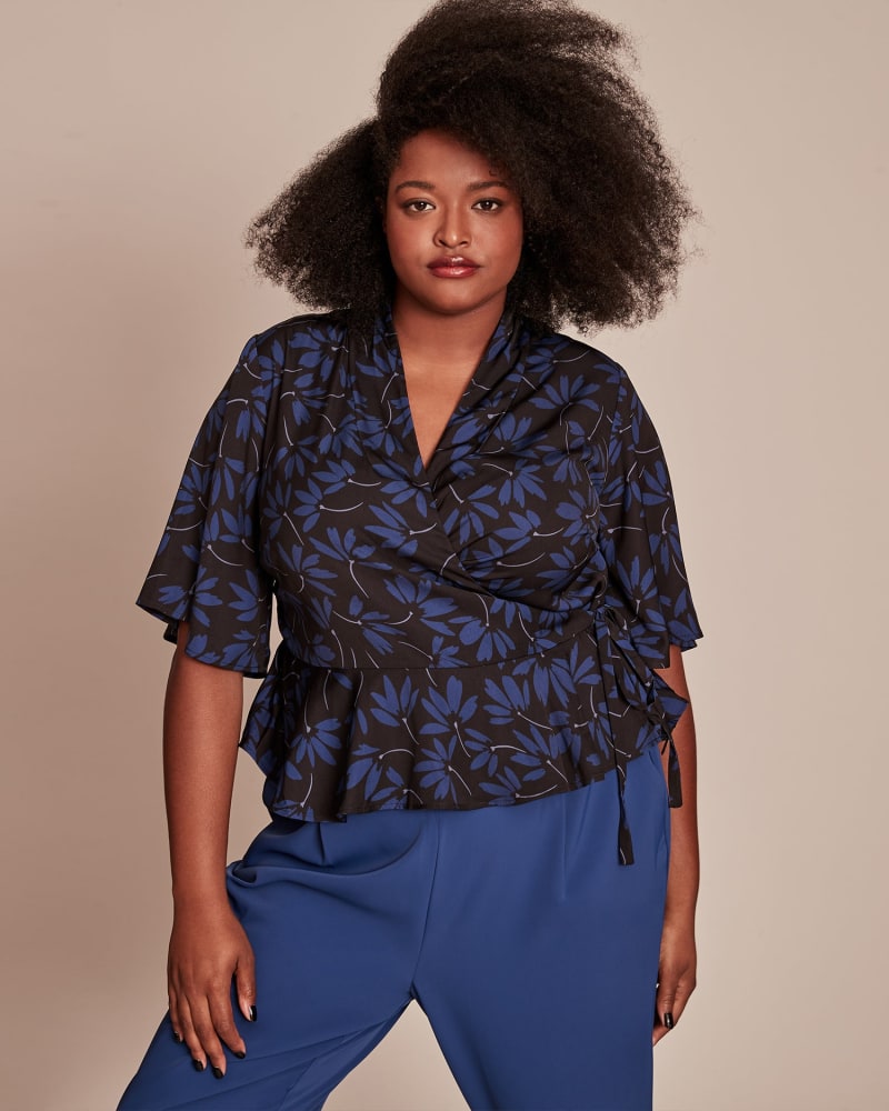 Front of a model wearing a size 12 Essie Wrap Blouse in NAVY by 11 Honoré Collection. | dia_product_style_image_id:224170
